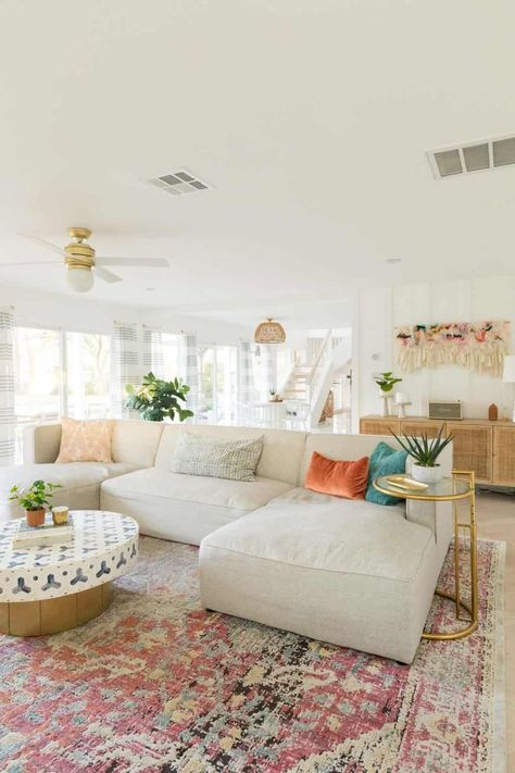 Tan Coach Living Room, Subtle Boho Living Room, Living Room Boho Colorful, Colorful Boho Design, Apartment Decorating Coastal Style, Pink Rug In Living Room, Area Rug Aesthetic, Bright Living Room Rug, Girly Apartments Living Room