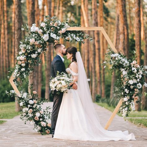 Our Wood Hexagon Wedding Arch is a perfect addition to your special day. Crafted with precision and elegance, this arch is designed to create a stunning focal point for your wedding ceremony or reception. Made from high-quality wood, the hexagon shape adds a unique touch of modernity to traditional wedding décor, making it a versatile choice for any theme or style. The Wood Hexagon Wedding Arch stands tall and sturdy, providing a stable structure for draping fabrics, flowers, or other decorative elements. Its natural wood finish adds a rustic charm, while the smooth edges and flawless craftsmanship ensure a polished look. The arch is easy to assemble and disassemble, making it convenient for transportation and storage. Whether you envision an outdoor garden wedding or an indoor celebration Wedding Ceremony Ideas, Country Wedding Arches, Wooden Wedding Arch, Wooden Wedding Arches, Backdrop Arch, Bridal Backdrops, Hexagon Wedding, Climbing Flowers, Wedding Ceremony Arch