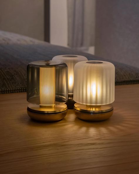 Such an amazing glow from an exquisite tealight, up to 220 hours of light from a single charge so no messy cables, it has 3 dimmable settings and comes in the most attractive colours of bronze and gold bases with a choice of frosted or smoked shades #elegantlights #lighting #lightdesigns #homedecor #interiors #pendants #lightingsolutions #essexlighting #chelmsfordlighting #lightingideas #exquisitelighting #lightinginspiration #luxurylighting #chandelier #ledlights #ceilinglighting #glassligh... Cordless Lamps, Design Lamp, Flickering Lights, Gold Table Lamp, Tealight, Firefly, Lamp Design, Light Table, Frosted Glass