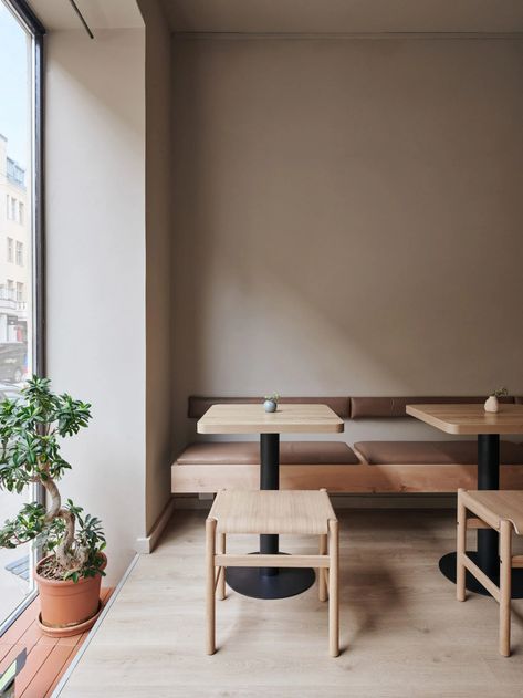 Yatofu uses "honest" materials to revamp Teemaa teahouse in Helsinki Textured Feature Wall, Kitchen Suite, Interior Minimal, Timber Table, Wall Niche, Vintage Stool, Steel Shelf, Retail Interior, White Curtains