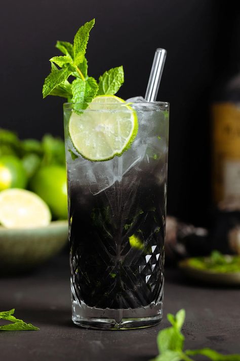 If you're a fan of the classic mojito, you'll love this Black Mojito with Activated Charcoal for Halloween! It's the perfect spooky cocktail for the holidays or for any party where you want your drinks to be a conversation starter! A non-alcoholic mocktail version is included. Charcoal has many health benefits and helps with hangovers! Black Mojito, Classic Mojito, Apple Cider Cocktail, White Drinks, Cider Cocktails, Warm Lemon Water, White Cocktails, Slice Of Lime, Rum Cocktails