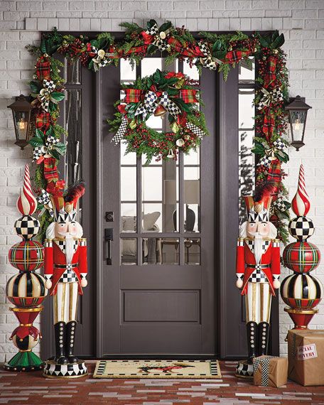 From berry-filled looks and traditional wreaths to fail-safe string lights and ornaments, check out our roundup of 41 Christmas door decor ideas to spark inspiration for your own home’s facade. #christmas #christmasdecorations #holiday #holidaydecor #decorations #home #frontdoor #doors #christmasideas #holidayideas #doordecoration #elledecor Castle Guard, Outside Christmas Decorations, Front Door Christmas Decorations, Christmas Front Doors, Christmas Porch Decor, White Christmas Decor, Christmas Porch, Front Porch Christmas Decor, Christmas Door Decorations