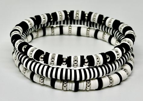 Set of 3 Black and White, hand beaded, stretch bracelets. Each strand is made with 6mm Heishi beads with silver accents. Can be customized with wording of your choice. Clay Beads Bracelet Halloween, Black And White Clay Bracelet, Heishi Bracelet Patterns, Black And White Clay Bead Bracelet, Male Bracelets, Bracelets Stacking, Bracelet Heishi, Stretch Beaded Bracelets Diy, Heishi Jewelry