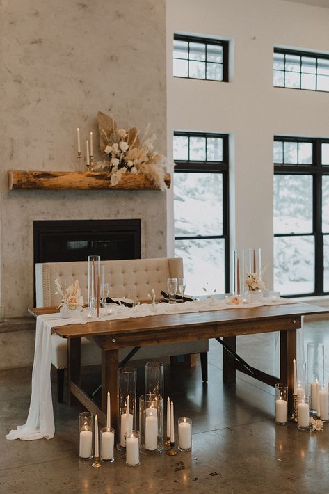 Dried florals, glass votives with candles and a tan color palette accompany a wooden sweetheart table. Neutral Sweetheart Table, Head Table Candles, Sweetheart Table Candles, Rustic Sweetheart Table, Wedding Sweetheart Table Decor, Wedding Couple Table, Minimal Wedding Decor, Head Table Wedding Decorations, Luxury Romance