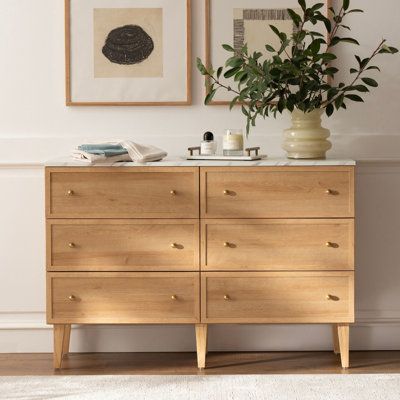 Upgrade your storage space and add a touch of elegance to your bedroom with our 6 Drawer Dresser. Its clean lines and neutral tones bring traditional style and natural warmth to any room. The quick and easy assembly process, sturdy engineered wood construction, and metal glides with safety stops make it a durable and practical choice for your busy lifestyle. Complete with sleek gold handles, this dresser is the perfect solution for all your storage needs. | Winston Porter Sivan 6 - Drawer Dresse Scandanavian Dresser, Minimalist Bedroom Wood Furniture, Light Wooden Dresser, Earth Tone Bedroom Dresser, Japandi Dresser Bedroom, Minimal Furniture Bedroom, L Shaped Dresser, Light Wood Dressers, Modern Wood Dresser