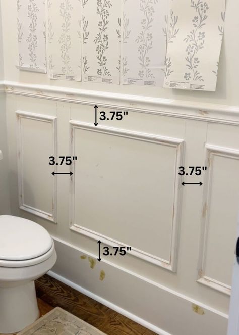 installation of picture frame molding on a wall with text overlay showing the space between each piece of trim Art Over Picture Frame Molding, Picture Frame Wall Molding Ideas, Box Molding Small Bathroom, Picture Frame Molding Door, Picture Frame Molding Half Bath, Picture Frame Molding Half Wall, Picture Moulding Bathroom, Chair Rail Molding Ideas, Bathroom Picture Molding