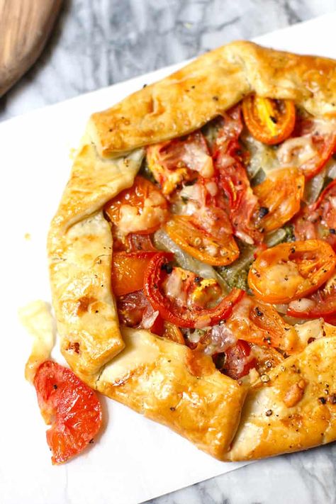 My Savory Italian Galette uses a store-bought pie crust, pesto sauce, sautéed onions, fresh tomatoes, and shaved parmesan cheese to create an amazing dish! Store Bought Pie Crust Recipes, Tomatoes And Goat Cheese, Tomato Galette, Dinner Pies, Store Bought Pie Crust, Shaved Parmesan, Sautéed Onions, Galette Recipe, Tomato Tart