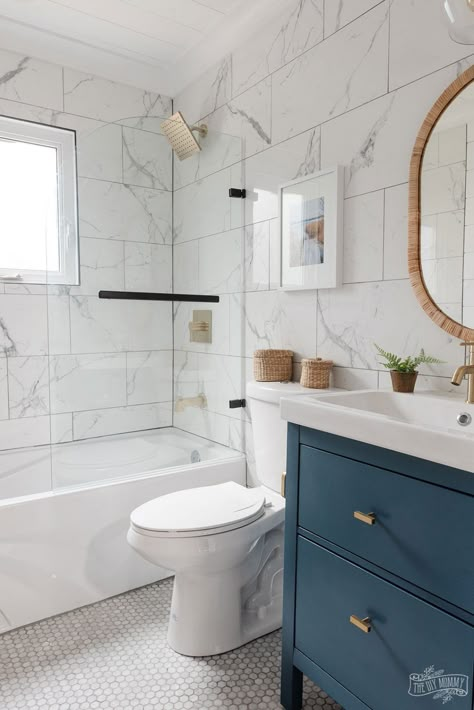 Modern coastal inspired bathroom renovation with marble tile, shiplap, gold and black accessories, clear shower door, blue and white colors & rattan accents Modern Coastal Bathroom, Coastal Bathroom Design, White Marble Bathrooms, Marble Tile Bathroom, Coastal Bathroom, Small Bathroom Renovation, Bad Inspiration, Bathroom Redesign, Coastal Bathrooms