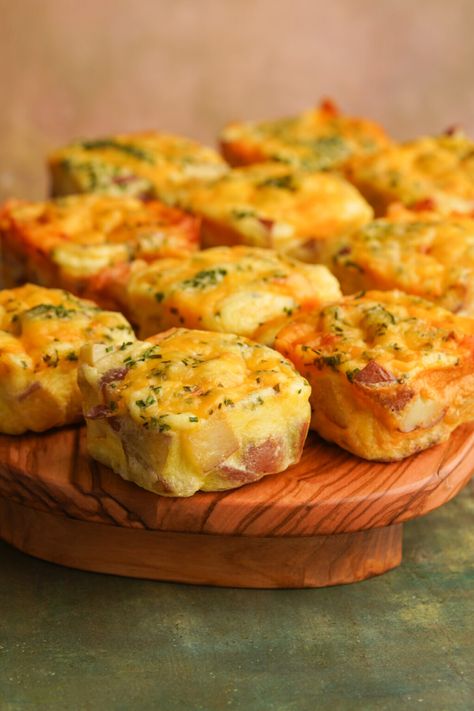 Skip the drive thru and make a batch of Starbucks Potato Cheddar Chive Bakes at home! They are a perfectly fluffy egg bite loaded with tender baked potatoes. Each bite gets topped with a layer of melty cheese and fresh chopped chives. Potato Cheddar Chive Egg Bake Starbucks Recipe, Copycat Starbucks Potato Egg Bites, Copycat Starbucks Potato Chive Egg Bites, Starbucks Potato Egg Bites Recipe, Potato Cheddar And Chive Bake, Potato And Chive Egg Bites, Egg And Potato Bites, Potato Cheddar Chive Egg Bites Starbucks, Starbucks Potato And Chive Egg Bites Recipe