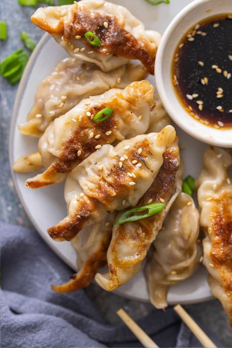 Stuffed with ground pork and cabbage, this Potstickers recipe far outshines anything you can buy at the store! Pan-fried then steamed, they're beautifully browned on the bottom and soft and tender on the top. Healthy Pot Stickers, Homemade Potstickers Dough, Pork Pot Stickers Recipe, Beef Potstickers Recipe, Potsticker Dough, Ground Pork And Cabbage, Pork Potstickers Recipe, Homemade Potstickers, Potsticker Sauce