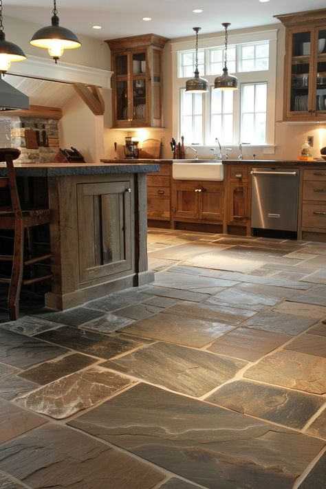 Add a unique twist to your kitchen with farmhouse kitchen flooring options that combine rustic and modern elements. 🏡🍴 Rustic Flooring Tile, Rustic Floor Tiles Living Room, Dark Stone Kitchen Floor, Kitchen Floor Next To Hardwood, Farmhouse Kitchen With Tile Floor, Non Wood Kitchen Floors, Rustic Kitchen Flooring Ideas, Log Cabin Flooring Ideas, Kitchen Tile Ideas Floor