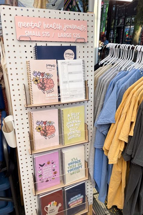 I love how this pegboard came together to display my mental health journals. The pegboard was used to display my journals at eye level and use more vertical space and not a lot of floor space. #craftfair #marketbooth #boothsetup #journaldisplay #notebookdisplay #pegboarddisplay Small Store Display Ideas, Journal Display, Craft Show Booth Display Ideas, Booth Display Ideas, Art Fair Display, Vendor Booth Display, Pegboard Display, Craft Market Display, Festival Booth