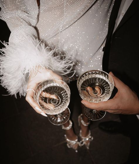 "Cheers to weekends filled with champagne, glitter, and a touch of feathered elegance! 🥂✨🕊️" @verenalilly in 'RIYA' Rhinestone dress 🤍 . . . Photo: @melanieundmarkus Set: @ccevents_hochzeitsplanung Models: @verenalilly & @bilal.heinrich . . . . . . . #weekends #weekendmood #weekend #weekendparty #afterparty #afterpartydress #rhinestones #rhinestonedress #glitterdress #glitterlove #glitterlook #partydress #featherdress #glitterfeathers #partyideas #partyinspiration #glamparty #glam #afterw... Glitz And Glam Accessories, Glitz And Glam Decorations, Glitz Bachelorette, Glitter And Glamour Party, Glitz And Glam Party, Glitz And Glam Party Decorations, Glitz And Glamour Party, After Wedding Dress, Glamour Party