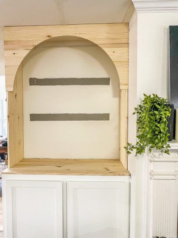 Arch Storage Wall, Built In Cabinet With Arch, Faux Arched Door, Painted Arch With Floating Shelves, Archway Built Ins, Built In Arch In Wall, Arched Cabinets By Fireplace, Diy Arch Built In Shelves, Arched Cabinets Built Ins