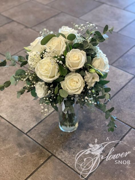 Beautiful bridal bouquet made with white roses, white lisianthus, touches of babys breath and a variety of eucalyptus greenery. Perfect for your traditional bridal bouquet, rustic wedding, fall wedding, spring wedding, summer wedding, winter wedding, green and white wedding. Bridal Flowers Bouquet Simple, White Green Flower Bouquet, Wedding Flowers White Roses Eucalyptus, Wedding Bouquets White Roses And Eucalyptus, Fall Wedding Bouquets November, Small White And Green Bridal Bouquet, Wedding Bouquet White Roses Eucalyptus, White Rose Eucalyptus Babys Breath Bouquet, Rustic White And Green Bridal Bouquet