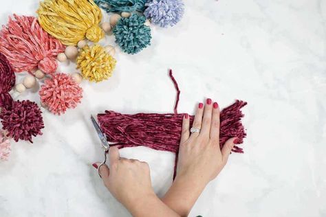 Create a Layered Pom Pom Tassel Garland with Velvet Yarn and Wooden Beads. Diy Yarn Garland, Rainbow Tassel Garland, Sweet Red Poppy, Diy Tassel Garland, Christmas Pom Pom, Velvet Yarn, Pom Pom Garland, Tassel Garland, Art Desk