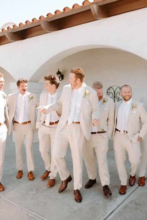 This groom is sporting a neutral tan suit with a navy tie for his summer wedding in Camarillo, California! Come see more groomsmen outfit trends, groom suit ideas, groomsmen style, california wedding venues, palm springs wedding venues, outdoor wedding venues in california, fall wedding inspiration, fall wedding ideas, and 2023 wedding trends. Book Kate for your luxury southern california wedding at kategarciaweddings.com! Tan Groomsmen Suits, Groomsmen Attire Beach Wedding, Groom Suit Ideas, Tan Suit Wedding, Tan Groomsmen, Wedding Venues In California, 2023 Wedding Trends, Palm Springs Wedding Venues, Groomsmen Outfit