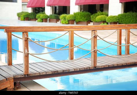 Wooden bridge over swimming pool in luxury hotel Stock Photo Pool Bridge, Lynn Canyon, Small Bridge, Luxury Swimming Pools, Thermal Spa, Natural Swimming Pool, Wooden Bridge, Blue Sky Background, Covered Decks