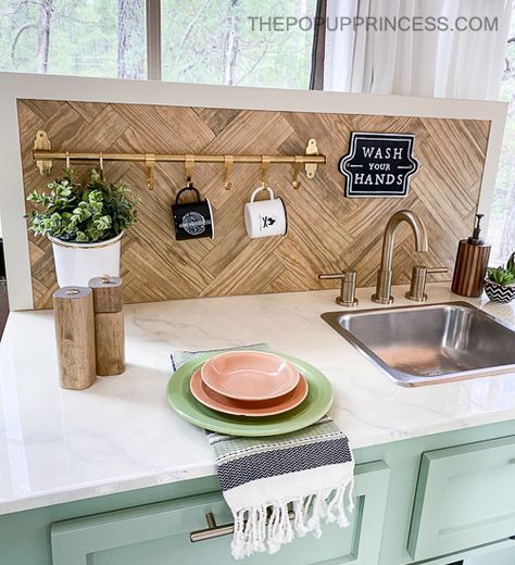 Transform your pop up camper with a simple, yet functional, backsplash. All you need is a few boards and some sash locks to complete the project. Boho Pop Up Camper, Pop Up Camper Interior Ideas, Pop Up Camper Storage Ideas, Pop Up Camper Organization, Camper Backsplash, Pop Up Camper Storage, Vintage Camper Renovation, Pop Up Camper Remodel, Apache Camper