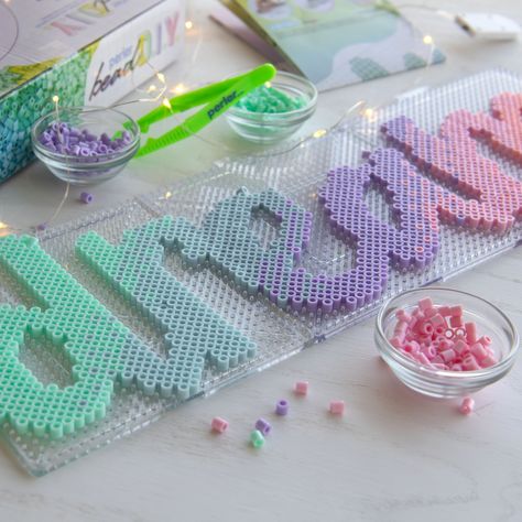 "Buy the Perler® Bead DIY Dream Light-Up Bead Art Kit at Michaels. Make a your own bedroom décor sign with this Perler bead DIY dream light-up bead art kit. Make a your own bedroom décor sign with this Perler bead DIY dream light-up bead art kit. Use the included Perler beads and pattern to spell out a pastel ombre, \"Dream,\" then wrap the letters in fairy lights, lean it up against the back of your desk or hang it on the wall. Turn on the lights to enjoy your cute DIY décor piece. Details: Inc Plastic Bead Crafts, Harry Potter Perler Beads, Melty Bead Designs, Pastel Ombre, Easy Perler Bead Patterns, Melty Bead Patterns, Pearl Beads Pattern, 3d Perler Bead, Bead Diy