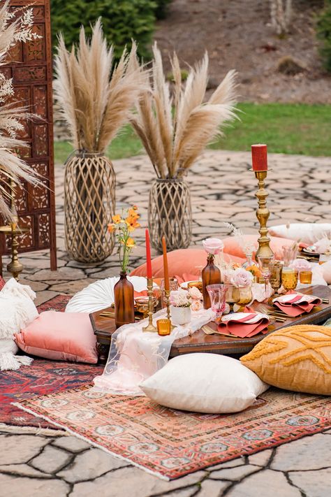 Sometimes people ask us what we would do if given the opportunity to let our creativity go a little crazy, and this tablescape might just be our answer 🤣 We had a vision to create a Moroccan-style tablescape using these low seated tables that we had recently added to our inventory, and from that starting point our design grew and morphed until we landed at this warm-paletted, cozy, and eclectic bundle of goodness! #Chattanooga #wedding #tablescape #Moroccan #lowtables #weddingtable #pampasgrass Howe Farms, Moroccan Nights, Moroccan Party, Indoor Picnic, Moroccan Theme, Chattanooga Wedding, Boho Picnic, Wedding Tablescape, Moroccan Wedding