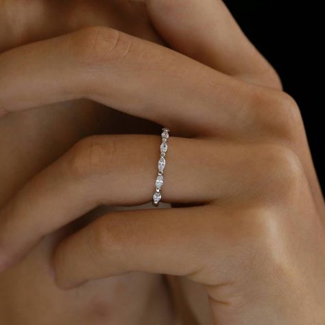 Our minimal marquise eternity band features 7 shimmering stones set sideways halfway around the ring. The delicate design of the band creates an elegant and timeless feminine look. It looks stunning as a wedding band on its own, or stacked with other rings as a statement piece. Each piece is made in sterling silver and dipped in White Gold (Rhodium) for extra shine and durability. Dainty Wedding Band White Gold, Simple Wedding Bands For Women Silver, Diamond Wedding Bands White Gold, Wedding Bands White Gold, Marquise Eternity Band, Wedding Bands Silver, Marquise Wedding Band, Minimal Wedding Band, Marquise Band