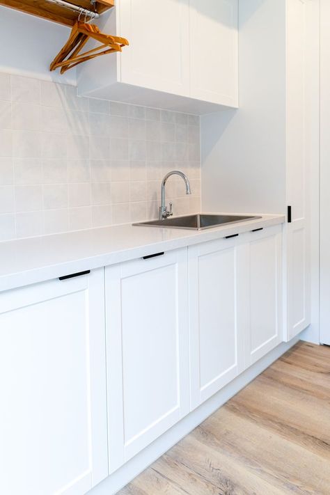 Shaker Kitchen With Black Handles, Overhead Laundry Cupboards, Shaker Style Laundry Room, Laundry Wall Tiles, Laundry Overhead Cupboards, Square Tile Splashback, Coastal Kitchens Australia, Kaboodle Kitchen Bunnings, Laundry Splashback Tiles