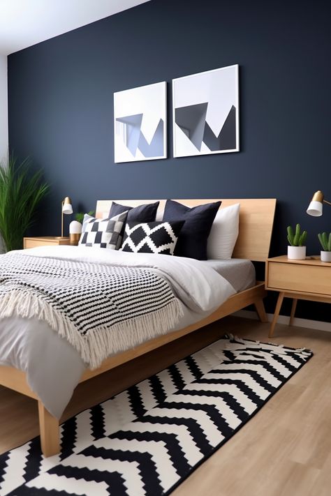 Photographed from an angle that captures the entire queen-size bed and most of the room, this modern Scandinavian bedroom features a midnight blue accent wall with white geometric patterns. Light wood furniture, a woven rug, and minimalist artwork complete the look. Midnight Blue Bedroom, Modern Scandinavian Bedroom, Blue Feature Wall, Blue Bedroom Walls, Dark Blue Bedrooms, Navy Blue Bedrooms, Feature Wall Bedroom, Scandinavian Bedroom, Accent Wall Bedroom