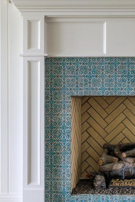 A white wooden fireplace mantel frames blue mosaic surround tiles. Mosaic Tile Fireplace, Mosaic Fireplace, Wooden Fireplace Surround, White Brick Fireplace, Contemporary Sconces, Blue Mosaic Tile, Marble Fireplace Mantel, Wooden Fireplace, Stone Tile Wall