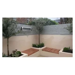 Smart contemporary courtyard. K Rend walls and raised planters, Built-in Iroko hardwood seating. Infra-red outdoor heater. Evergreen planting including Courtyard Landscaping Ideas, K Rend, Built In Garden Seating, Contemporary Courtyard, Raised Planters, Scandinavian Garden, Rooftop Patio Design, Home Decor Ideas Bedroom, Small Courtyard