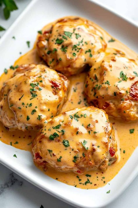 Juicy, tender chicken thighs smothered in a rich, creamy sun-dried tomato sauce make these Crockpot Marry Me Chicken Thighs an irresistible dish! This easy recipe is ideal for meal prep and tastes like a restaurant-quality meal right at home. #CrockpotMeals #ChickenRecipes #CreamySauce #DinnerTime Chicken Thigh Marry Me Chicken, Chicken Thigh Thanksgiving Recipes, Boneless Chicken Thigh Meals, Crockpot Thigh Recipes, Chicken Thigh Recipes With Tomatoes, Chicken Thigh Crockpot Meals, Chicken Thigh Recipe Crockpot, Thigh Crockpot Recipe, Crockpot Thighs Boneless