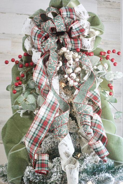 "PLEASE READ ENTIRE LISTING THERE ARE SOME CHANGES: Limited for 2023! Velvet Tree Topper. We are seeing a shift back to traditional Christmas. This Old World, Velvet Tree Topper is combined with a modern luxury unequalled on the market. A designer, high end, Christmas Tree topper, features a luxurious sage velvet ribbon, green red and white plaid ribbon, birch ribbon and a sage ribbon with white snowflakes. Also comes with a realistic eucalyptus and lambs ear greens and faux berries. Tree Topper Red And Sage Christmas Tree, Green And Ivory Christmas Tree, Bows For Tree, Green Christmas Tree Topper, Sage Green And Red Christmas Decor, Red And Sage Green Christmas Tree, Boho Christmas Tree Topper, Green Velvet Ribbon Christmas Tree, Mesh Ribbon Christmas Tree