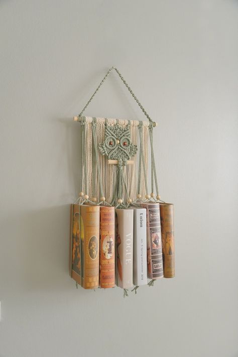 "Enhance your reading nook with our exquisite Macrame Book Holder featuring a charming Macrame Owl design. This unique and functional piece of room decor combines the elegance of macrame with the practicality of a hanging bookshelf. Perfect for the bohemian home, it adds a touch of mid-century modern style to your book storage while making a delightful gift for book lovers and best friends alike. This Macrame Book Holder is handcrafted/ hand woven with Natural Friendly Cotton Cord. DETAIL: Dimensions (taken without books): - Length: 24.8\"W ~ 62cm - Width: +  6 books: 14\" ~ 35cm + 8 books: 18\" ~ 45cm  + 10 books: 22\" ~ 55cm + 12 books: 26\" ~ 65cm NOTE: - NO books included. - The item is made to order, the listing photos are examples and the detail of actual products may vary a little b Handcrafted Home Decor, Macrame Book Shelf, Macrame Book Hanger, Macrame Bookshelf, Unique Macrame Ideas, Macrame Book Holder, Functional Macrame, Macrame Holder, Come Intrecciare