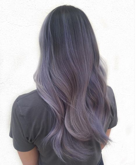 If you like ombre styles and unnatural shades, we've got a beautiful new hair color for you: smoky lilac. As seen in this sweeping look by hairstylist Kendall Noel, smoky lilac hair transitions from a deep grayish purple down to a pale, foggy lavender. The result: a mysterious, unique shade that looks especially lovely on longer hair. Lilac Hair Color, Rainbow Hair Color, Hot Hair Colors, Lilac Hair, Hair Color Pastel, Lavender Hair, Hair Color Purple, Pastel Hair, Limes