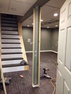 Before I start talking about the support pole, I want to mention a little project I did that I am super thrilled with. I knew I wanted to pu... #basementideas Basement Poles, Basement Decoration, Dream Basement, Basement Layout, Stairs Makeover, Staircase Remodel, Diy Basement, Waterproofing Basement, Basement Apartment