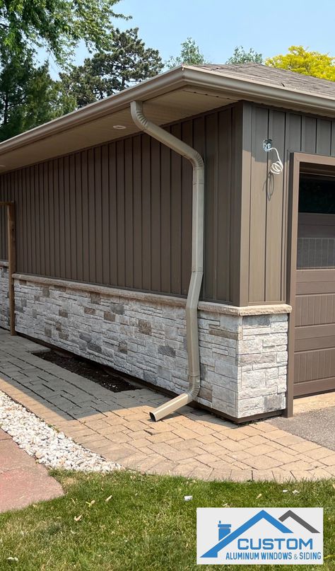 House with vinyl Board & Batten siding in Rockport Brown and Versetta Stone in Mission Point Colour Homes With Vertical Siding, Vynil Siding House Exterior With Stone, Stone With Board And Batten Exterior, Siding Alternatives Exterior, Replacing Siding On House, Outdoor Siding Ideas, Versetta Stone Exterior, Gentek Siding, Board And Batten Siding Colors