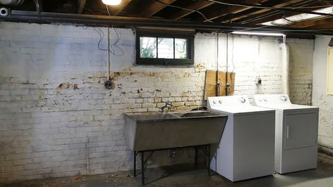 An old white washer and dryer sit next to a metal sink in front of a dirty white brick wall. Scary Basement, Basement Laundry Room Makeover, Old Basement, Basement Redo, New Washer And Dryer, Basement Remodel Diy, Basement Laundry Room, Basement Inspiration, Basement Laundry