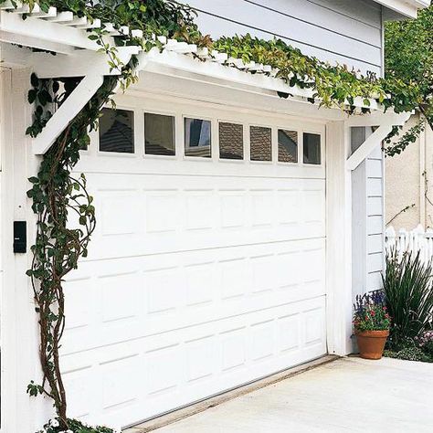 Garage Door Pergola - Compact and simple, this garage door pergola is an affordable weekend project and an easy way to dress up a garage.    Two matching assemblies of horizontal girders (basically short projecting beams) and knee braces support a pair of long crossbeams, which are topped by a series of short 2x2 rungs, creating the appearance of a horizontal ladder. Spirea Landscaping, Door Pergola, Pergola Metal, Attached Pergola, Garage Pergola, Diy Curb Appeal, Garage Door Styles, Arbors Trellis, Pergola Design