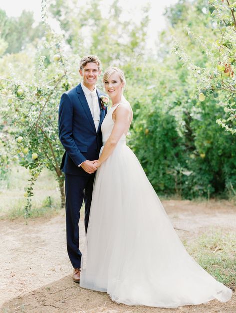 Bride in a classic Mikaella Bridal gown smiling at the camera with the groom in a navy linen suit. Full Belly Farm on Martha Stewart Weddings by film photographer Cavin Elizabeth Photography Pai, Wedding Photos Looking At Camera, Bride And Groom Looking At Camera, Navy Linen Suit, Wedding Pictures Beach, Farm Wedding Ceremony, Short Bride, Mikaella Bridal, Outdoor Wedding Photography