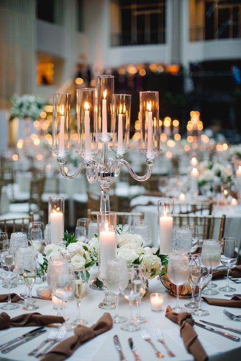 Classic arm crystal candelabra centerpiece with petite arrangements surrounding the base and more candlelight. PC: Asya Photography https://asyaphotography.com/ Candle And Flower Centrepiece, Candle Abras Wedding, Candle Bar At Wedding, Large Candle Centerpieces Wedding, Candelabra Wedding Centerpieces Flowers, Candle Opera Centerpiece Wedding Ideas, Candles As Centerpieces, Chandelier Table Centerpiece, Wedding Table Candelabras