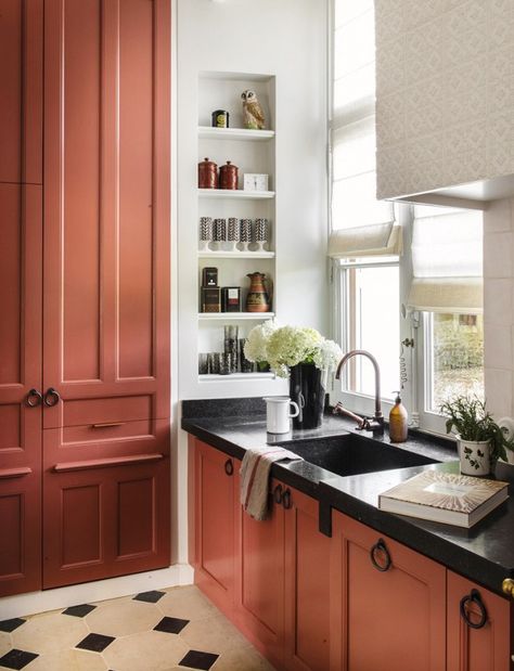 White is all right, but salmon is slammin'. French design firm D.Mesure made a one-of-a-kind choice with these brick-red cabinets and speckled black marble countertops. When opting... Red Kitchen Cabinets, Terracotta Kitchen, Kitchen Niche, Red Cabinets, Colorful Kitchen Decor, Black Countertops, Kitchen Cabinet Colors, Red Kitchen, Trendy Kitchen