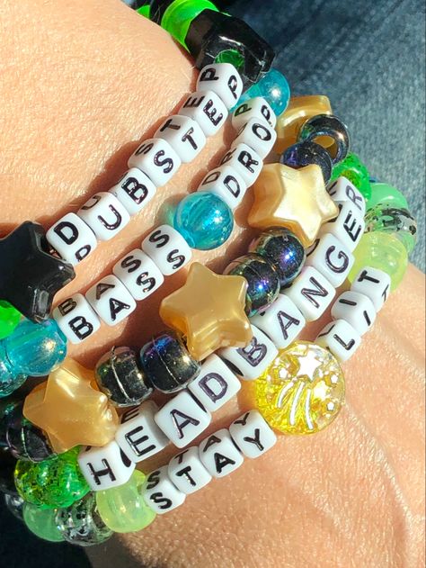 5 Dubstep themed Kandi beaded bracelets You will receive these exact bracelets *Dubstep *Headbanger *Stay Lit *Bass Drop *Pearly Gold Stars & Black Iridescent We make our Kandi bracelets using stretch string Available Sizes: OSFM 5 - 5.5 inches 5.5 - 6 inches 6 - 6.5 inches 6.5 - 7 inches 7 - 7.5 inches 7.5 - 8 inches 8 - 8.5 inches 8.5 - 9 inches Please send us a message to let us know what size bracelets you need. If you need a size not listed please contact us and we’ll be happy Lgbtq Kandi Bracelets, Alt Friendship Bracelet, Candy Bracelet Ideas Rave, Kandi Spike Cuff, Kandy Ideas Rave, Clay Beads Patterns, Candy Bracelets Rave, Candy Rave Bracelets, Cute Bracelet Making Ideas