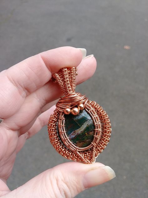 "\"Bloodstone in Copper\" Is a one of a kind multi colored bloodstone pendant wrapped and woven in bare copper wire with copper bead accents. Bloodstone is said to increase courage, motivation, and creative energy. Comes on either an 18 or 24 inch bare copper ball chain. Note this piece will naturally patina/darken over time, it could with some people's chemistry turn skin green (which can be easily washed off)." Pond Diorama, Copper Wire Crafts, Goldfish Pond, Handmade Crystal Necklace, Green White Red, Wire Wrap Jewelry Designs, Wire Jewelry Making, Resin Pendant Necklace, Necklaces Handmade