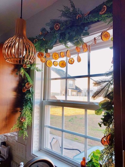 While searching for holiday decor inspo I came across dried fruit garland and fell in love! I have a window over my kitchen sink I decorated with garland and decided to spruce it up a bit! Here's the garland I have over my kitchen sink window. I love this garland by itself but knew it needed just a lil something more. I bought this garland from Joann's this year. Materials NeededTo dry your fruit of choice, I used oranges and lemons you'll need cooling racks, a knife, paper towels Dried Orange Slices Decoration Window, Orange Garland Window, Oranges Garland, Dried Fruit Garland, Taper Candle Centerpiece, Natural Garland, Fruit Garland, Witchy Christmas, Window Garland