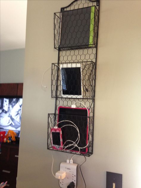 We have numerous devices between tablets and phones in my house. I've been trying to figure out a way to charge them but keep them off the counter. And then it hit me. Picked up this letter/file holder from Home Goods for $19.99. It is secure to the wall with heavy duty screws/anchors so it won't come crashing down. - Chord organization - iPad iPhone charger Wall Charging Station Ideas, Charging Stations Ideas, Apartment Organization Ideas, Ipad Charging Station, Craft Room Organization Ideas, Charging Station Organizer, Charger Storage, Room Organization Ideas, Phone Charging Station