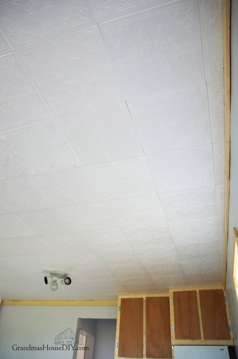 Easy to install Styrofoam do it yourself ceiling tiles over an ugly ceiling, how to Covering Ceiling Tiles, Ceiling Tile Replacement Ideas, How To Cover Ceiling Tiles, Styrofoam Ceiling Tiles Ideas, Painting Ceiling Tiles, Ceiling Tiles Diy, Basement Ceiling Insulation, Basement Ceiling Ideas Cheap, Ceiling Alternatives