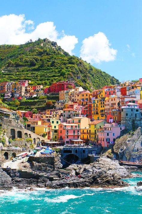 Manarola, Italy - It's in the province of La Spezia, Liguria, northern Italy. A unique place called 'Cinque Terre ' (which means Five Towns literally and this is one of the town, they are right next to each other). If you go to Tuscany, you can make a day trip there. Riomaggiore Italy, Colorful Buildings, Colorful Houses, Cinque Terre Italy, Grand Cayman, Vatican City, Machu Picchu, Pretty Places, Dream Destinations