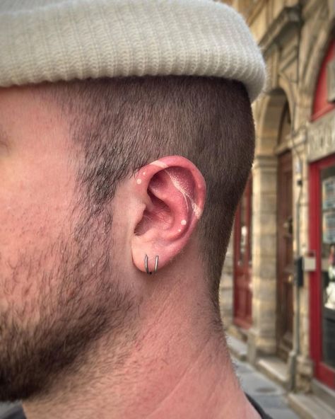 White inked ear tattoo design Ear Tattoo Inner Men, Healed Ear Tattoo, White Tattoo Ear, White Ink Ear Tattoo, Men’s Ear Tattoo, White Ear Tattoo, Wing Ear Tattoo, Tattoos By Ear, Under The Ear Tattoo