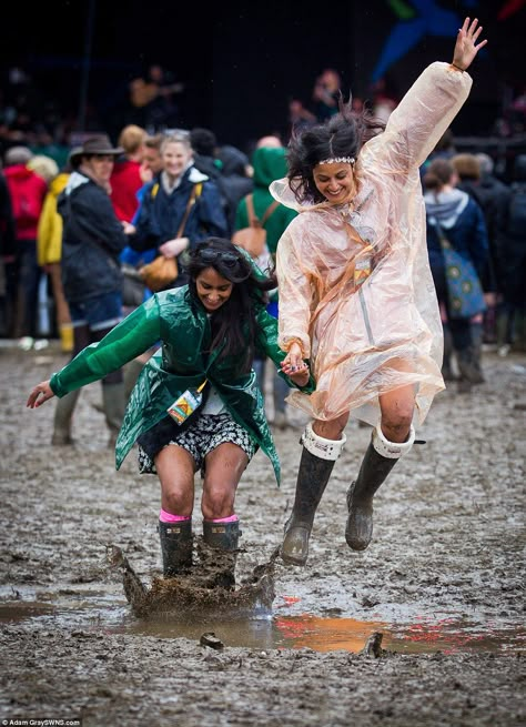 Priya Madhavji and Reena Solanki, 29, enjoy themselves in the mud infront of the Pyramid Stage at Glastonbury Festival, Pilton, Somerset. 28 June 2014. Wet Festival Outfit, Parklife Outfit, Festival Outfit Rain, Muddy Wellies, Glastonbury Festival Fashion, Rubber Apron, Glastonbury Fashion, Pyramid Stage, Lightning Storms