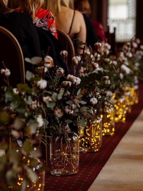 Create an eclectic aisle design for the perfect wedding ceremony #aisle #weddingflowers #churchflowers Candles Down Aisle Wedding Outside, Vase Aisle Decor, Fairy Lights Aisle Wedding, Wedding Aisle Trees, Simple Aisle Wedding Decor, Forest Wedding Aisle Decor, Art Deco Wedding Aisle, Autumn Wedding Isles Decoration, Moody Wedding Aisle Decor